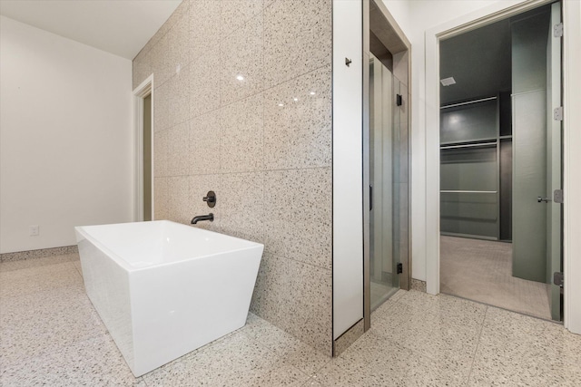 12001 Vicksburg Ave, Lubbock, TX 79424 - bathroom with a soaking tub, tile walls, and a shower with shower door