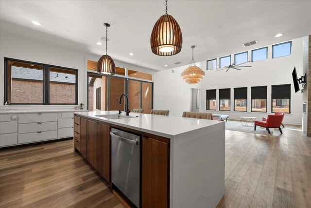 12001 Vicksburg Ave, Lubbock, TX 79424 - kitchen with a sink, stainless steel dishwasher, open floor plan, a kitchen island with sink, and light countertops