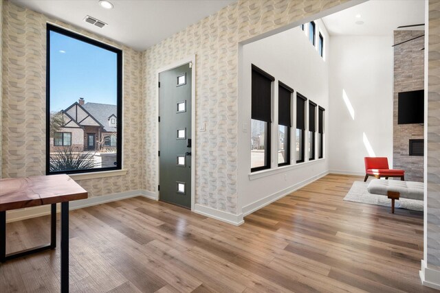 12001 Vicksburg Ave, Lubbock, TX 79424 - foyer entrance with baseboards, wood finished floors, and a large fireplace