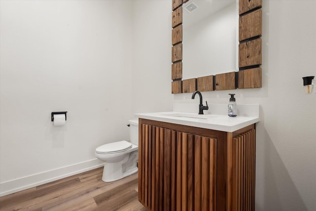 12001 Vicksburg Ave, Lubbock, TX 79424 - half bath with vanity, toilet, wood finished floors, and baseboards