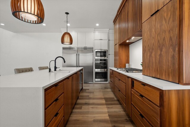 12001 Vicksburg Ave, Lubbock, TX 79424 - kitchen featuring built in appliances, dark wood-style floors, brown cabinets, light countertops, and recessed lighting