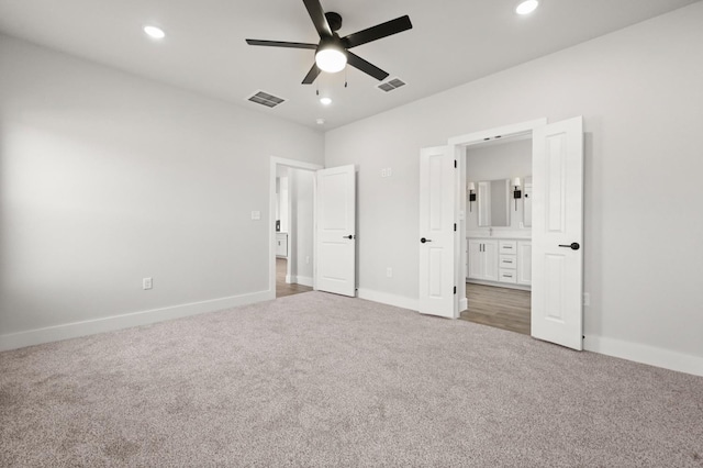 unfurnished bedroom with connected bathroom, carpet floors, and ceiling fan