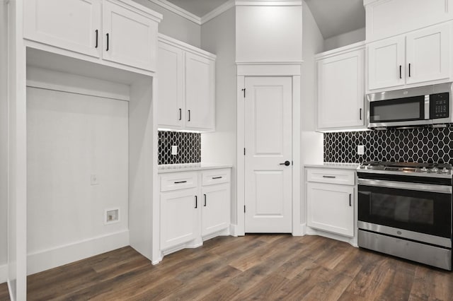 kitchen featuring dark wood-type flooring, stainless steel appliances, and white cabinets