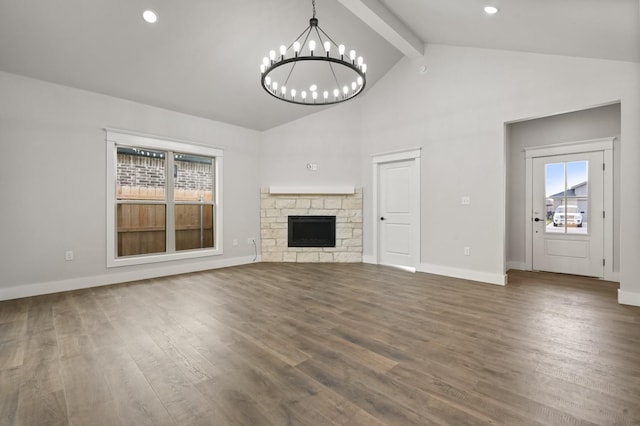 unfurnished living room featuring a stone fireplace, an inviting chandelier, high vaulted ceiling, dark hardwood / wood-style floors, and beamed ceiling