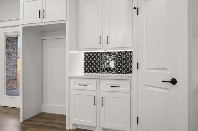 interior space featuring tasteful backsplash, white cabinetry, and dark hardwood / wood-style floors