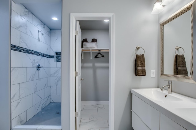 bathroom featuring vanity and tiled shower