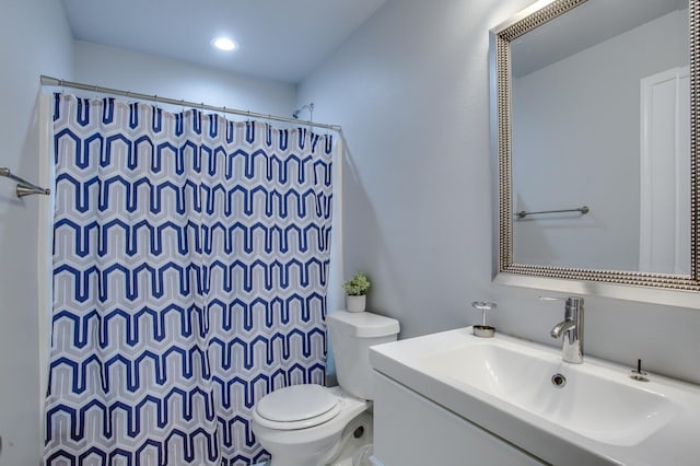 bathroom featuring vanity, toilet, and walk in shower