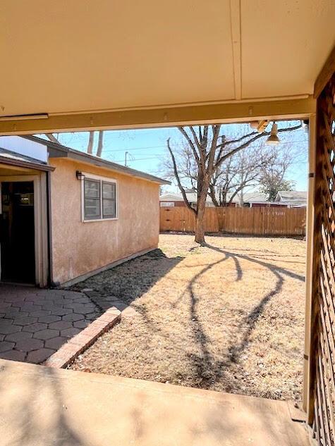 view of yard featuring a patio area and fence