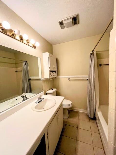 full bath featuring visible vents, toilet, a textured ceiling, vanity, and tile patterned flooring