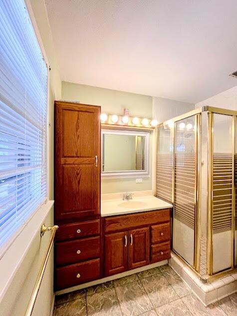 bathroom featuring visible vents, a shower stall, and vanity