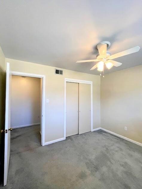 unfurnished bedroom featuring carpet floors, a closet, visible vents, and baseboards