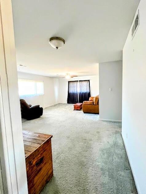 interior space with baseboards, visible vents, and carpet flooring