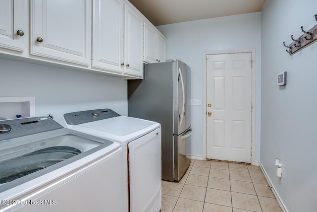 8 W Canyonview Dr, Ransom Canyon, TX 79366 - laundry room with washer and clothes dryer, light tile patterned floors, cabinet space, and baseboards