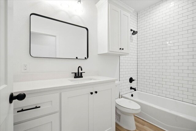 1406 Durham Ave, Wolfforth, TX 79382 - bathroom with vanity, wood finished floors, and washtub / shower combination