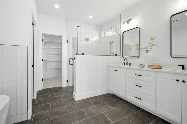 1406 Durham Ave, Wolfforth, TX 79382 - full bath featuring a shower stall, double vanity, a spacious closet, a freestanding bath, and recessed lighting