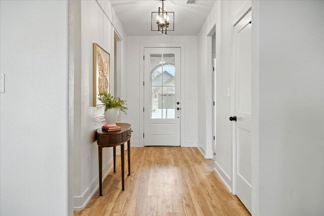 1406 Durham Ave, Wolfforth, TX 79382 - foyer entrance with a chandelier and light wood-type flooring