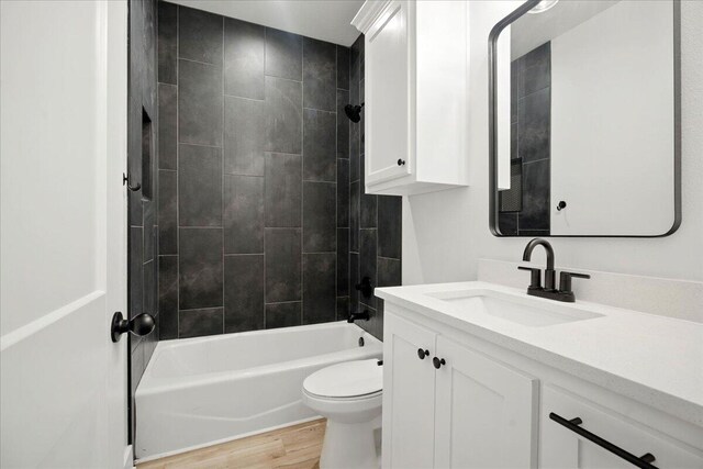 1406 Durham Ave, Wolfforth, TX 79382 - bathroom featuring vanity, wood finished floors, and bathing tub / shower combination