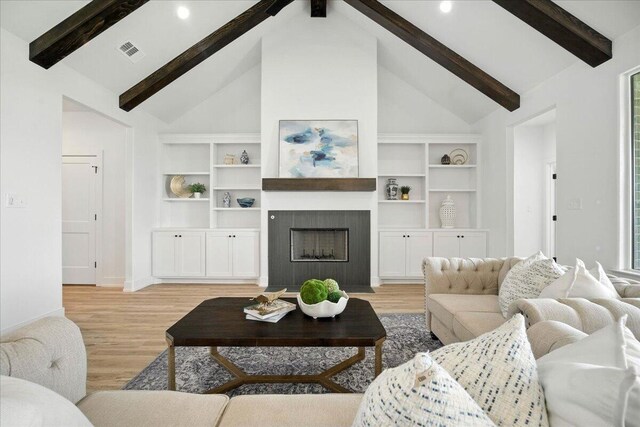 1406 Durham Ave, Wolfforth, TX 79382 - living area featuring beamed ceiling, light wood finished floors, a tiled fireplace, high vaulted ceiling, and recessed lighting