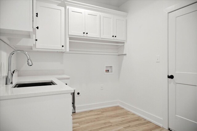 1406 Durham Ave, Wolfforth, TX 79382 - washroom with cabinet space, hookup for a washing machine, light wood finished floors, and electric dryer hookup