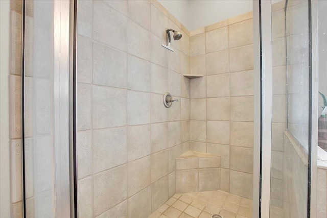 bathroom with a tile shower