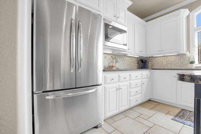 kitchen featuring stainless steel refrigerator, white cabinetry, backsplash, and built in microwave