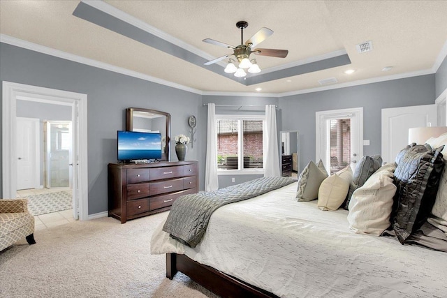 bedroom featuring crown molding, a tray ceiling, light carpet, and a textured ceiling