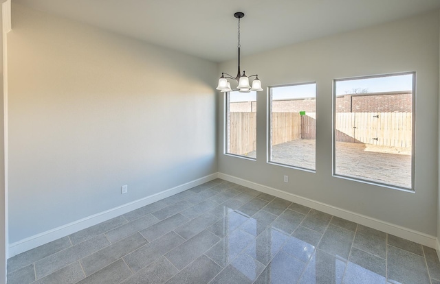 empty room featuring a chandelier