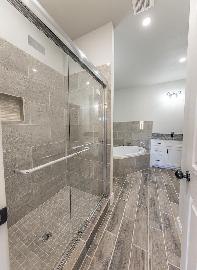 bathroom featuring shower with separate bathtub