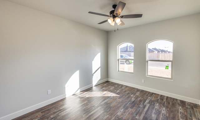 spare room featuring dark hardwood / wood-style flooring and ceiling fan