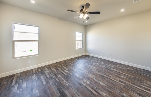 empty room with ceiling fan and dark hardwood / wood-style floors