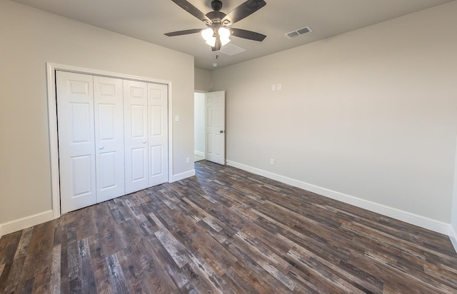 unfurnished bedroom with ceiling fan, dark hardwood / wood-style floors, and a closet