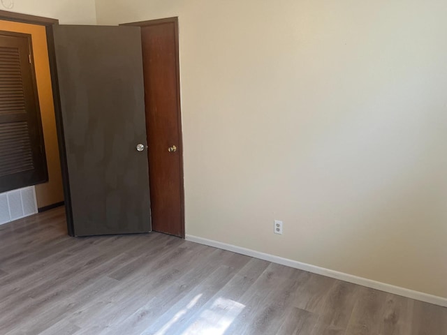 unfurnished bedroom with light wood-type flooring