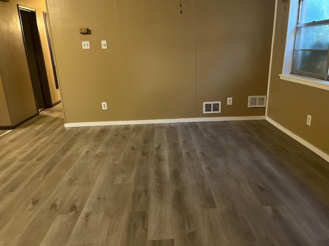 unfurnished room featuring dark hardwood / wood-style floors