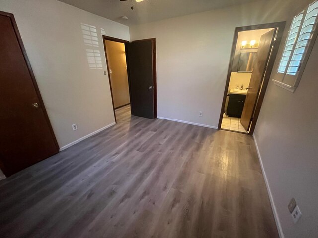 unfurnished bedroom with connected bathroom and light hardwood / wood-style floors