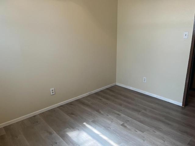 empty room with dark hardwood / wood-style floors