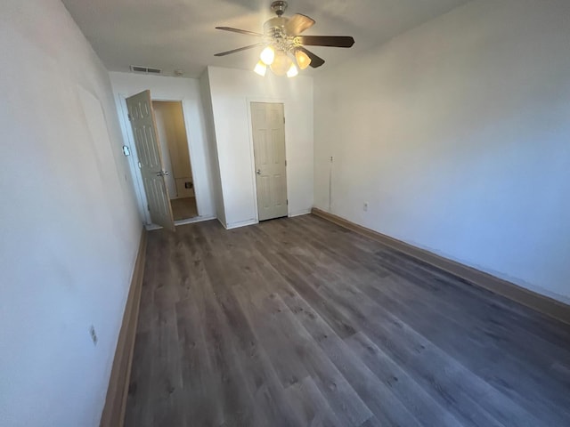 unfurnished bedroom featuring dark wood-type flooring and ceiling fan