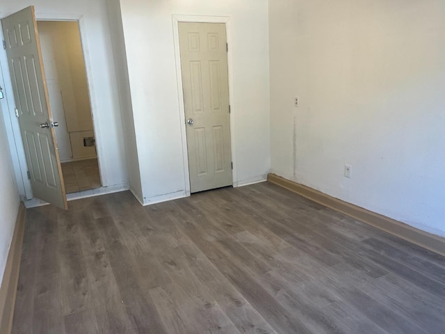 unfurnished bedroom featuring dark wood-type flooring