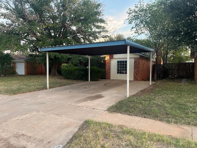 view of parking with a carport and a yard