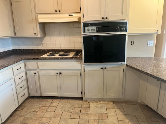 kitchen featuring white cabinetry, backsplash, oven, and white electric stovetop