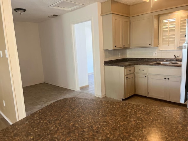 kitchen featuring sink and backsplash