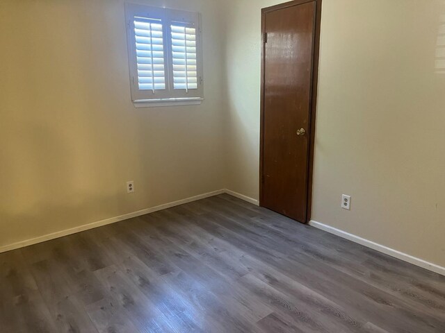 unfurnished room featuring dark hardwood / wood-style flooring