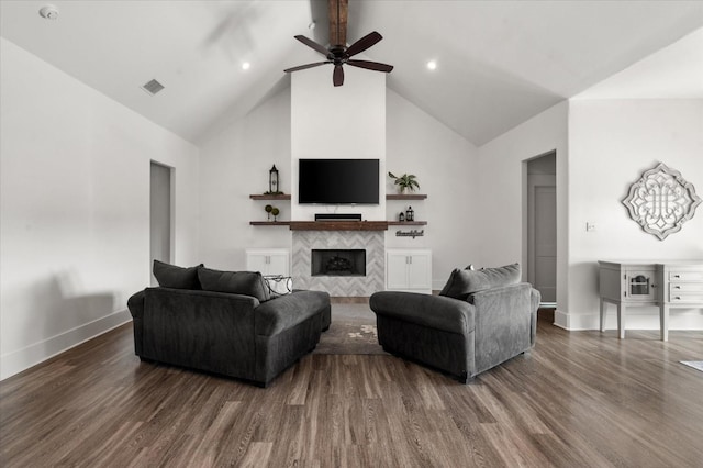 living room featuring dark wood-type flooring, high vaulted ceiling, a tile fireplace, beamed ceiling, and ceiling fan