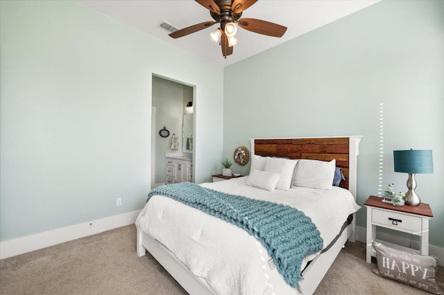 carpeted bedroom with ceiling fan and ensuite bathroom