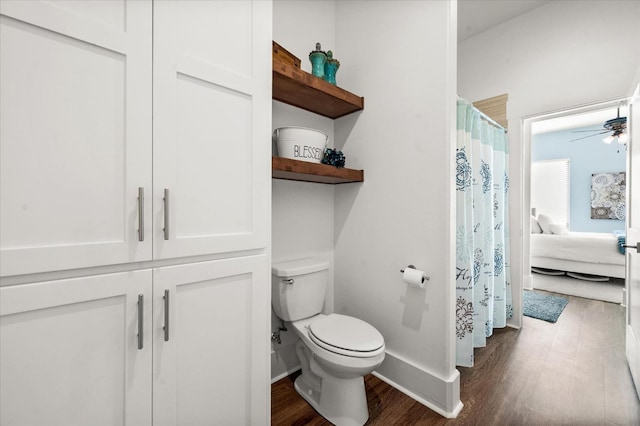 bathroom featuring hardwood / wood-style flooring, ceiling fan, and toilet