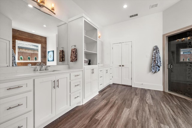 bathroom with vanity, hardwood / wood-style floors, and an enclosed shower