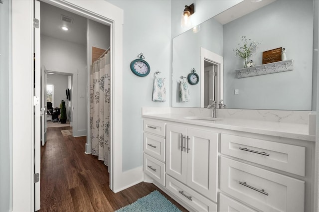 bathroom with vanity and hardwood / wood-style floors