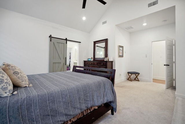 bedroom featuring ceiling fan, a barn door, light carpet, and high vaulted ceiling