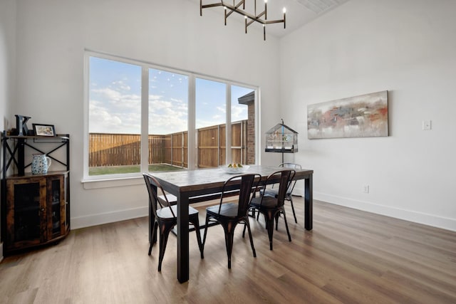 dining space featuring an inviting chandelier and hardwood / wood-style floors