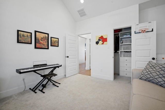 office area with light colored carpet and vaulted ceiling