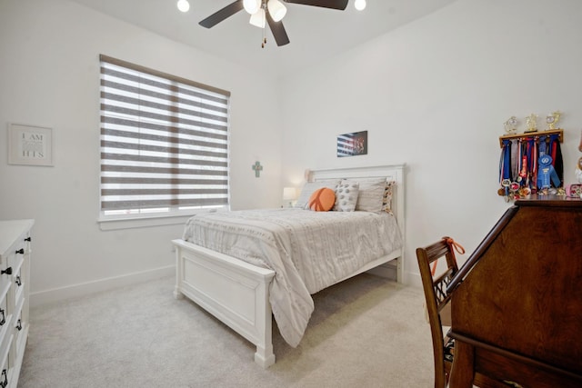 bedroom featuring light colored carpet and ceiling fan